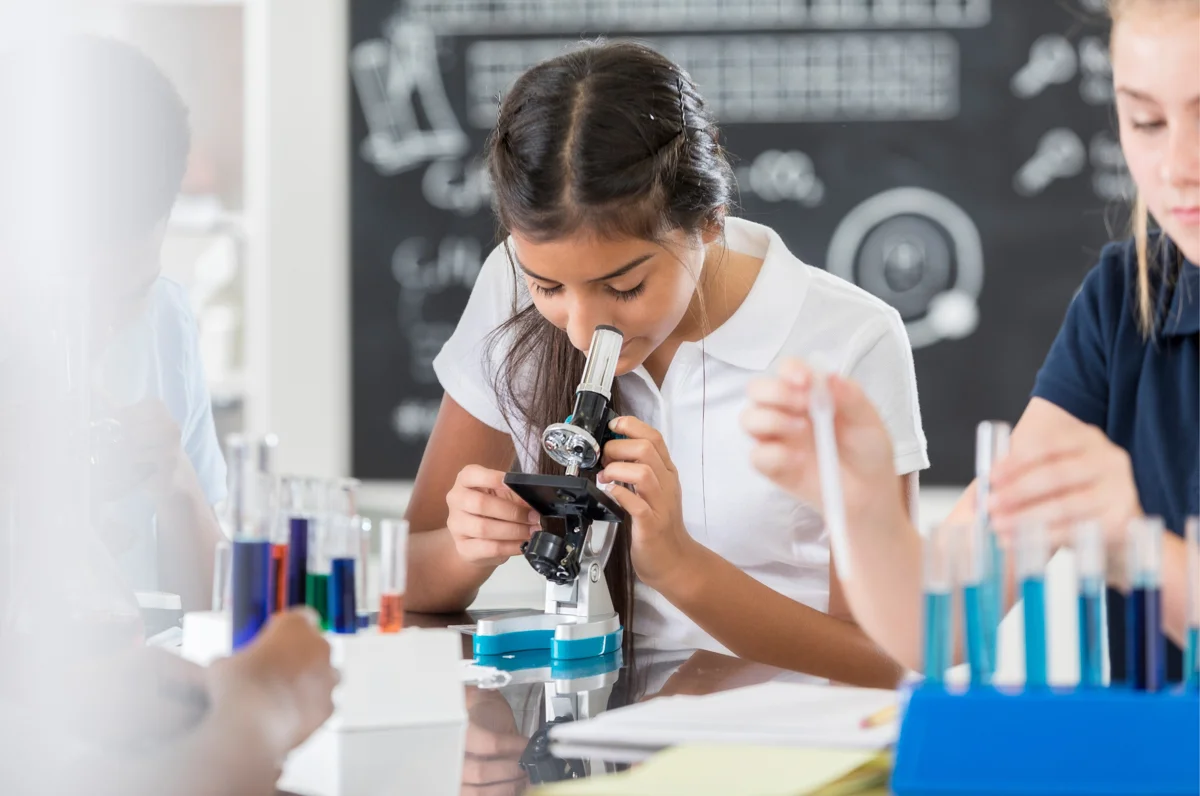 new rochelle private middle school student looking in a microscope
